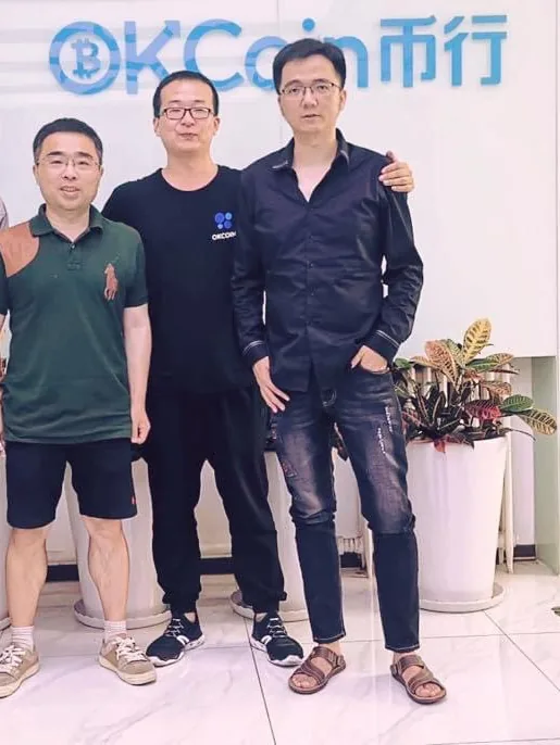 MrNasdog, on the right, with two people at the OKX office in Beijing, under the OKCoin sign